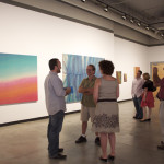 David Michael Lee of Coastline Community College Art Gallery engages patrons.