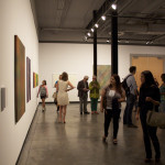 Patrons enjoying Tony de los Reyes exhibition.