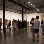 Patrons enjoying Tony de los Reyes exhibition.