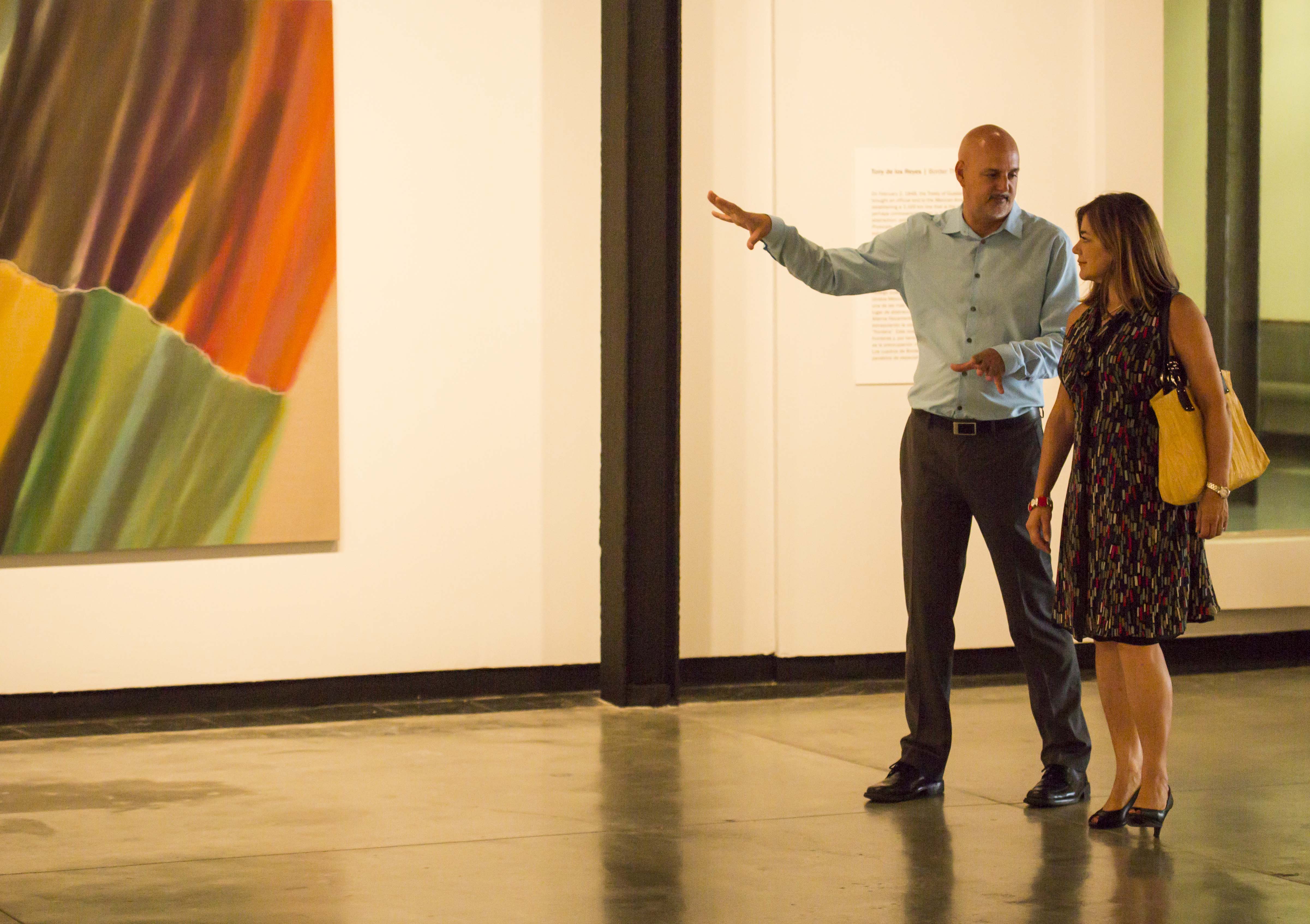 GCAC Director/Chief Curator John D. Spiak and Congresswoman Loretta Sanchez with the work of artist Tony de los Reyes.