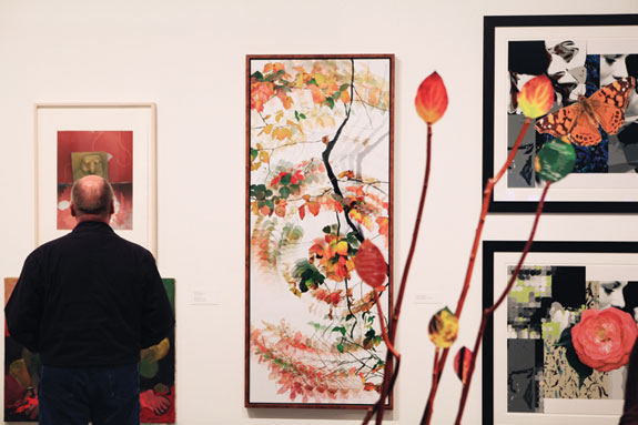 Man looking at artworks