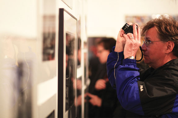 Man taking picture of artworks in the gallery
