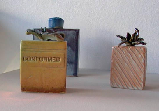 Three ceramic perfume bottles.