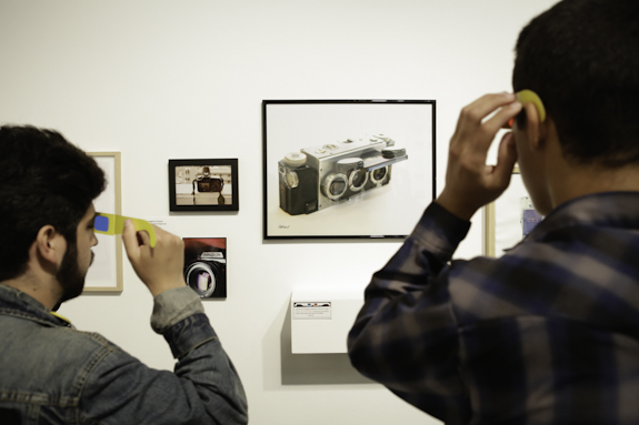 Visitors observing a photography exhibit.