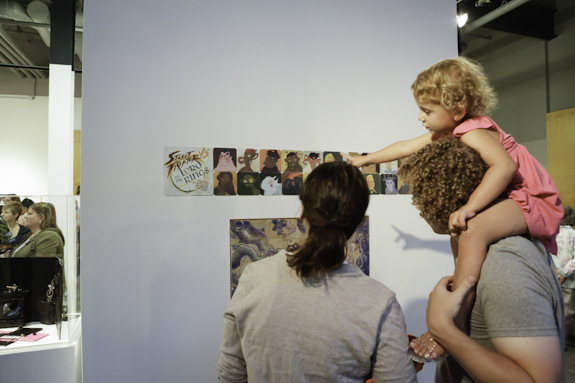 Family enjoying an illustration exhibition.