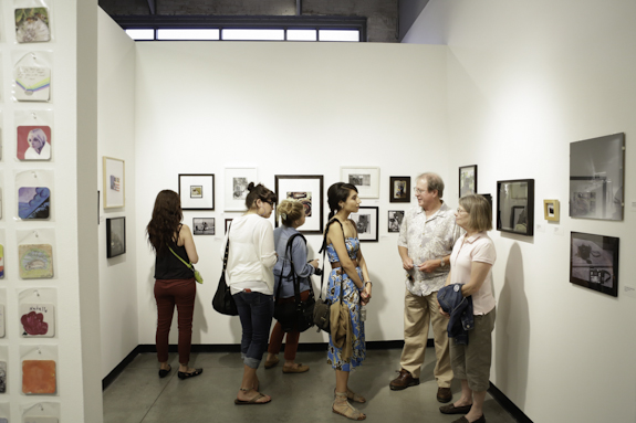 Visitors enjoying photography exhibition.
