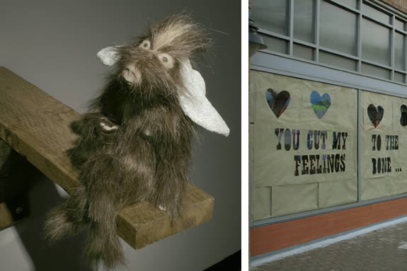 Small goat figurines sitting on wood block. Image of window from outside of building with the words "You cut my feelings to the bone.." cut out of paper.