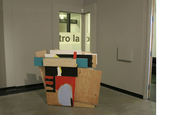 Wood panels painted and stuck together in abstract form.