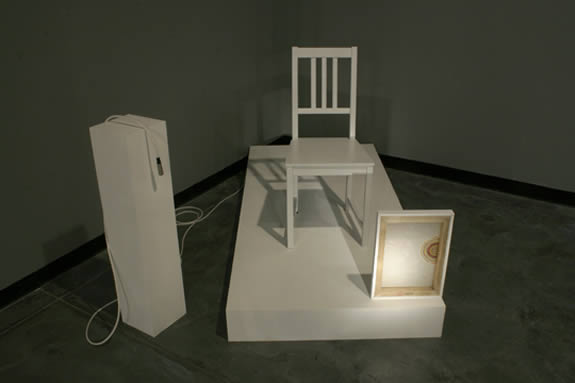 Installation of white chair on pedestal.