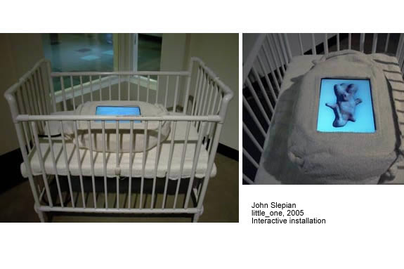 crib with a screen inside displaying abstract object.