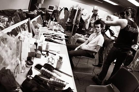 Individuals backstage, getting ready