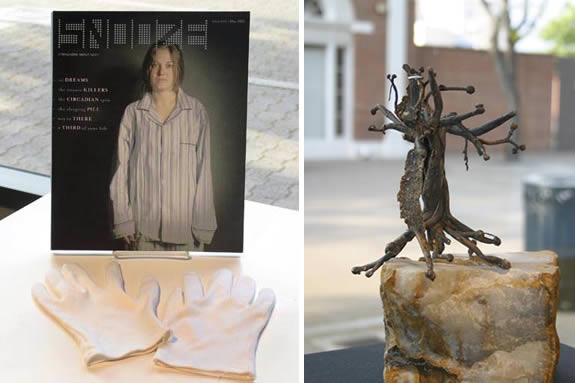 Friends and Family. White gloves infront of a picture of a woman and an abstracted sculpture made from a rock and iron