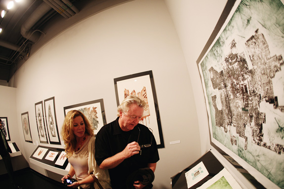Two people photographing the Fornaci exhibit.