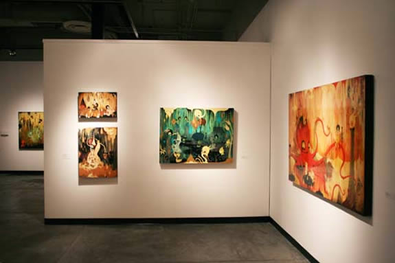 four artworks on white walls.