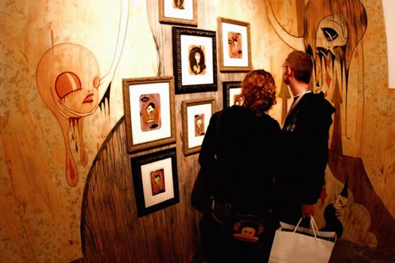 Two figures looking at paintings on walls (garcia,2005)