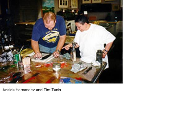 Anaida Hernandez and Tim Tanis at a table working on a project.