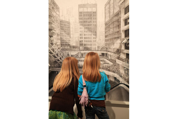 Two children look at artwork