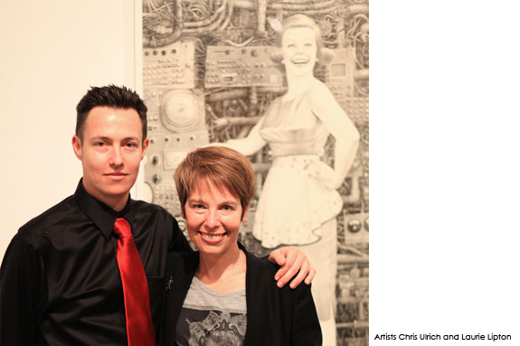 Two artists standing in front of artwork