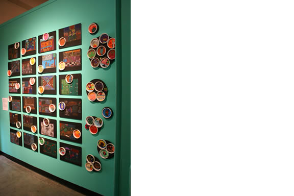 Teal wall with artwork covering the wall.