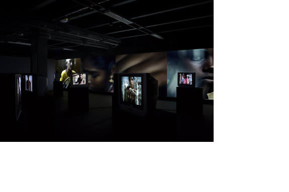 installation shot of projections of faces