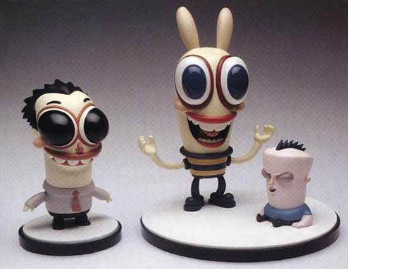 three toy figurines, large eyes and big heads. Two human forms and a bunny.