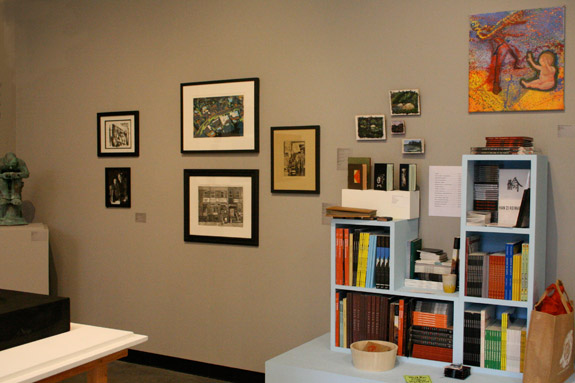 room with shelving and art hung on the wall.