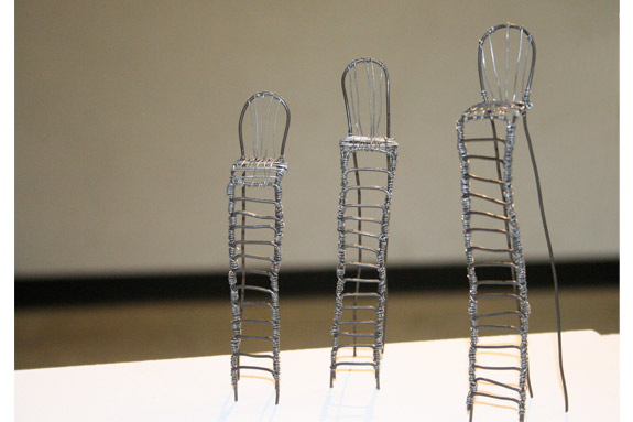 small chair figurines, tall and surrealist.