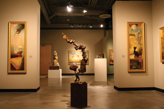installation shot of sculpture in the middle with art works surrounding