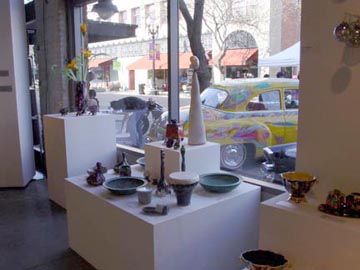 installation shot of various bowls on white pedestals, (Von Dutch: An American Original)