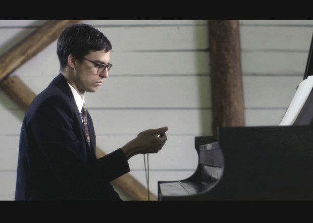 a guy timing his piano