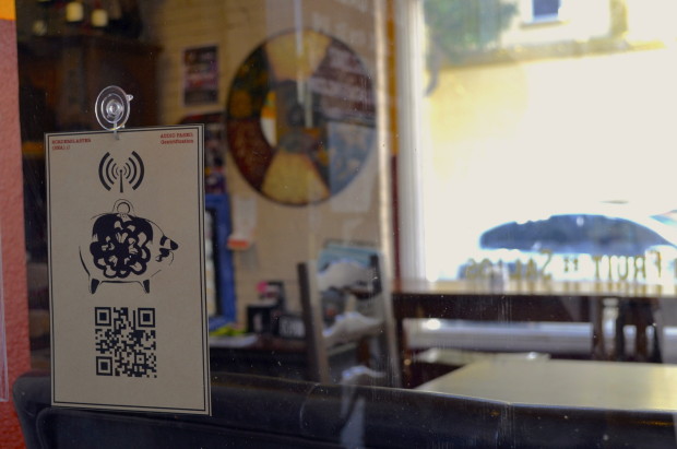 A QR code sign hangs in the window