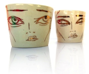 Two mugs with gold faces.