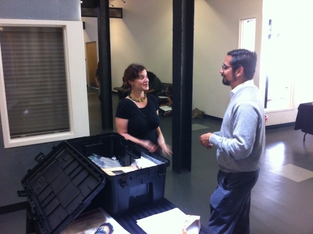 Two people conversing in front of time capsule