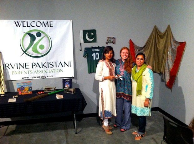 Three women standing and looking at the camera.