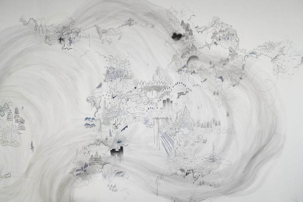 The mural is predominantly white, with intricate, almost microscopic details drawn in shades of gray.