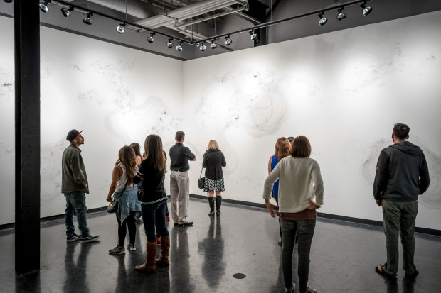 Audience members enjoying the wall drawing installation Flux by Jasmin Sanchez
