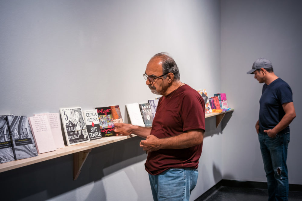 Two men looking at books
