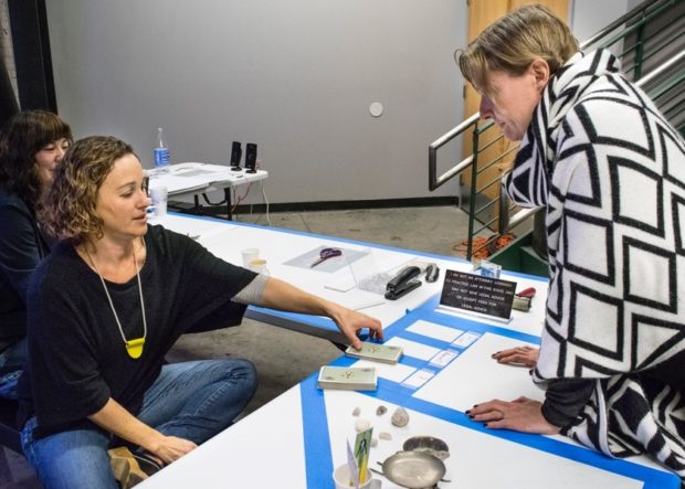 Deborah Fisher reading a customer’s tarot cards during Artwalk.