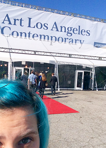 Half of Lainey Larosa's face infront of the Arts Los Angeles Contemporary banner