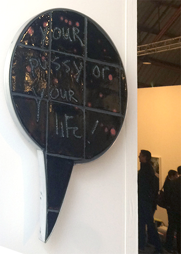 Black tiled sculpture bubble stating "Your Pussy or Your Life" by Liz Craft