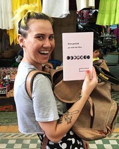 Excited person with a copy of free period zine