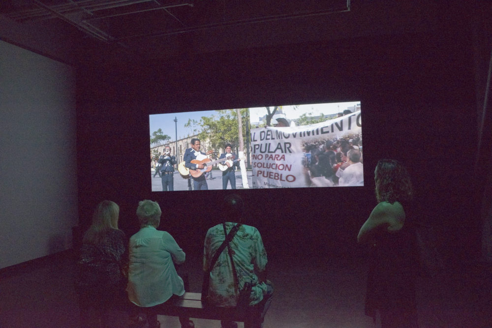 Figures watching video installation