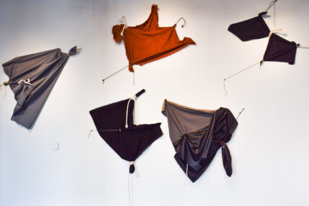 installation of fabric pinned to the wall with ropes