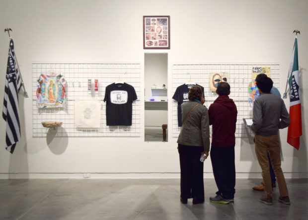 a group of people viewing a wall installation for Regionalia