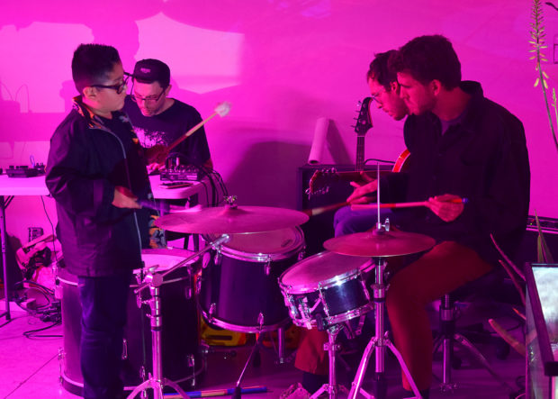 Child playing the drums in The Fountain Performance