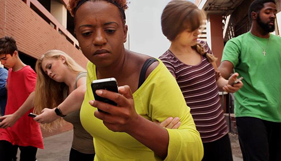 individuals in locked arms looking at cell phones