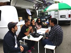 Artist Misael Diaz sitting with participants from the local community