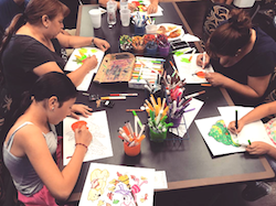 A group of kids coloring.