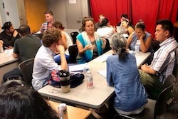 A group of people sitting in a workshop discussion