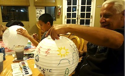 A group of people painting paper lanterns